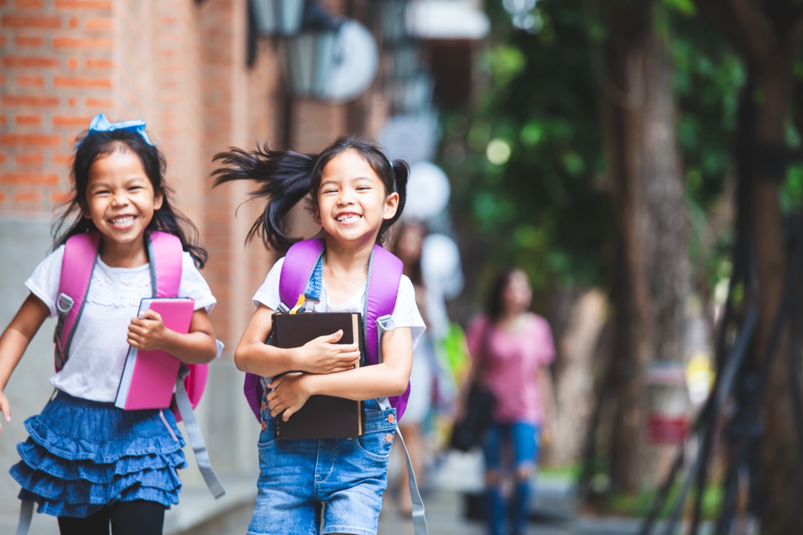 リュックを背負って学校へ走る女の子たち